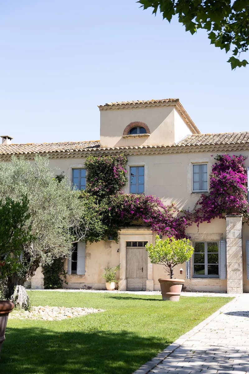 Farmhouse with blue shutters and bougainvillea, olive trees and a paved path