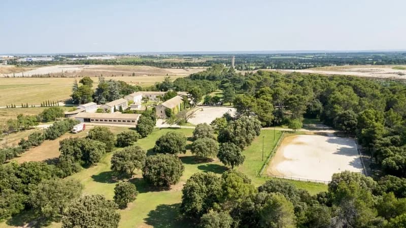 Aerial view of the estate, its buildings and wooded grounds
