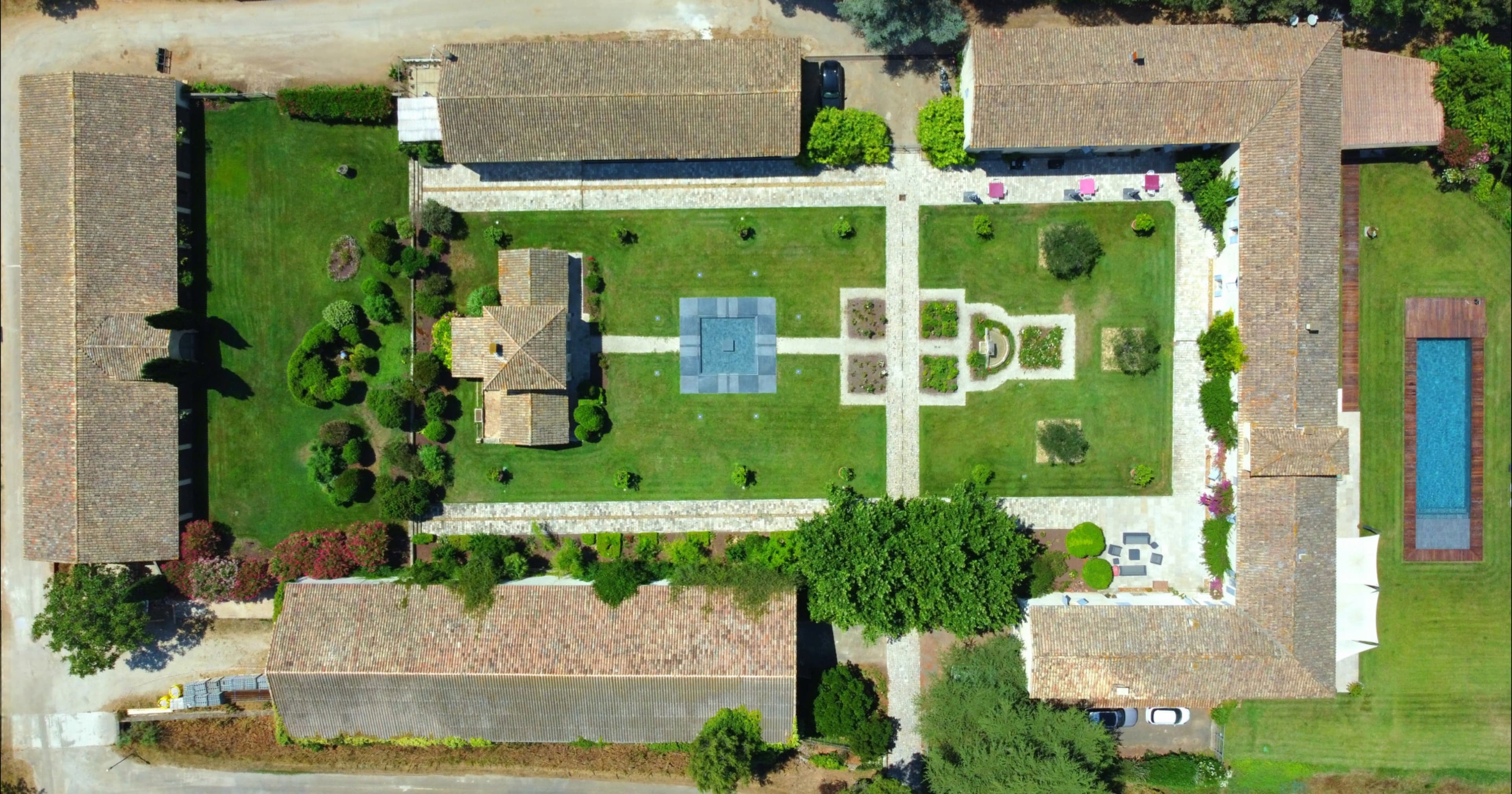 Aerial view of the estate buildings and their lawned courtyard